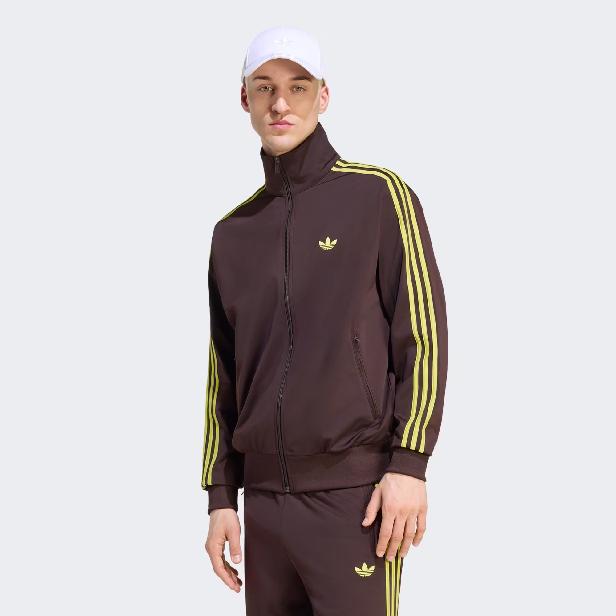 Model wearing a brown Adidas Firebird track jacket